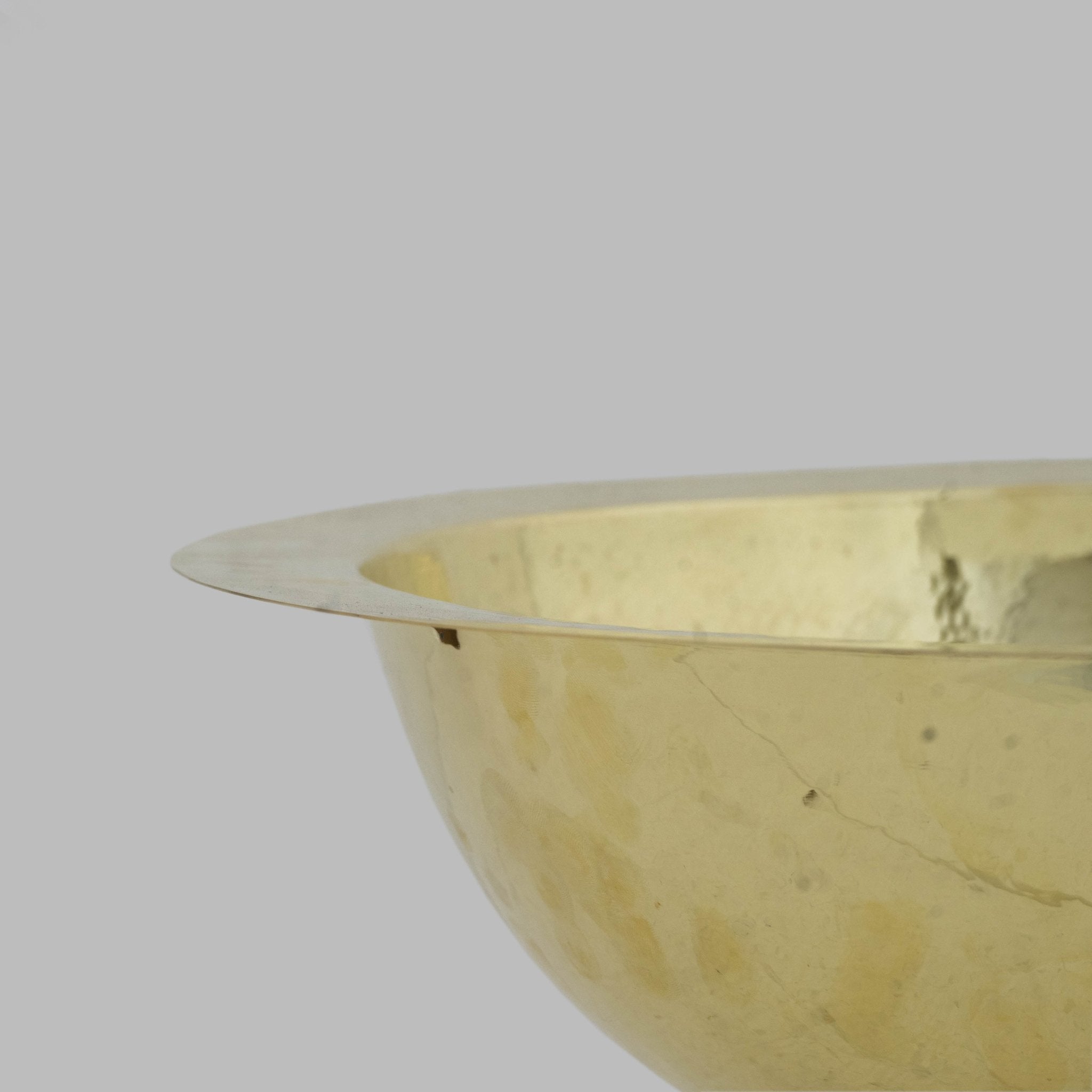 Round hammered brass sink detail