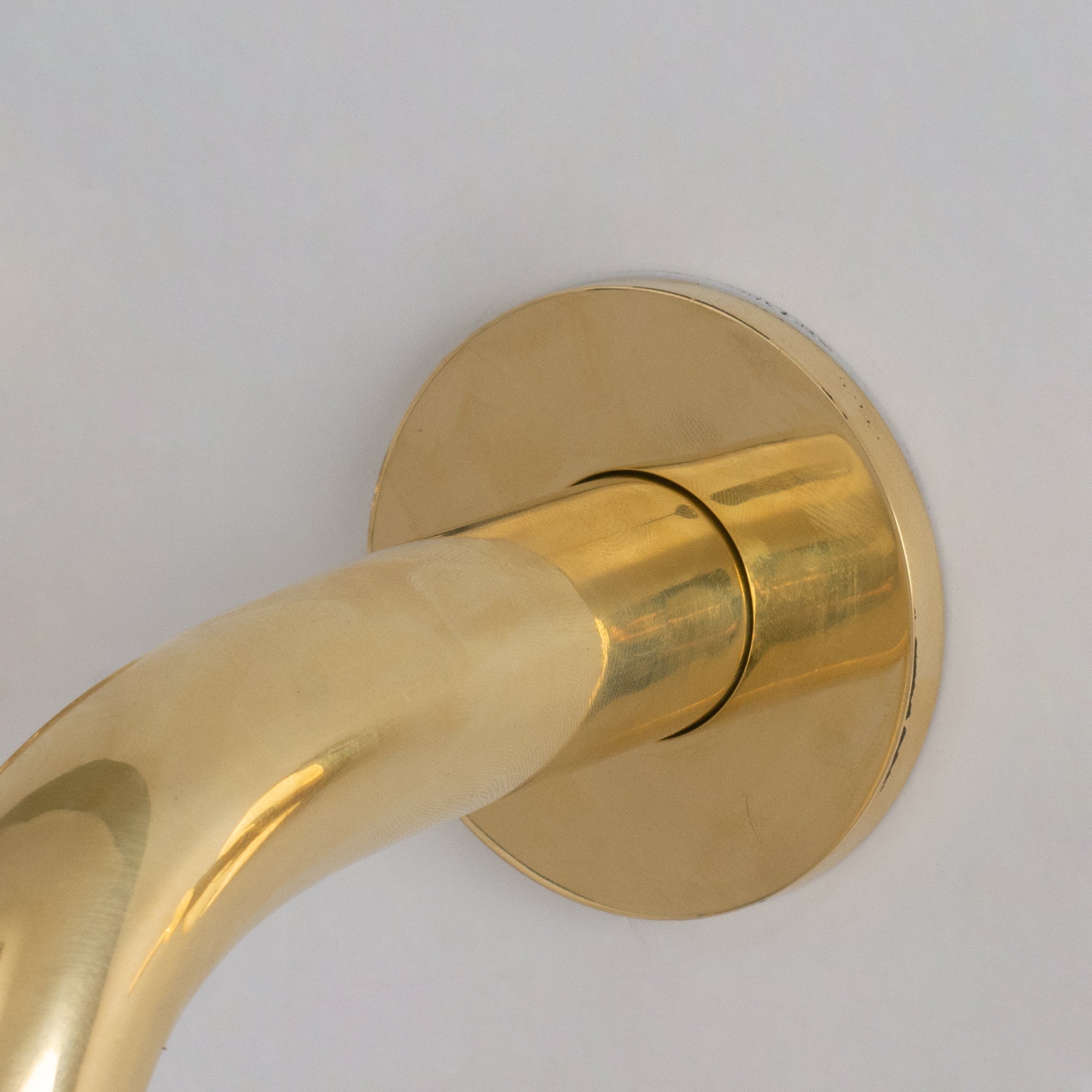 Wall fixation detail of the brass mini spout